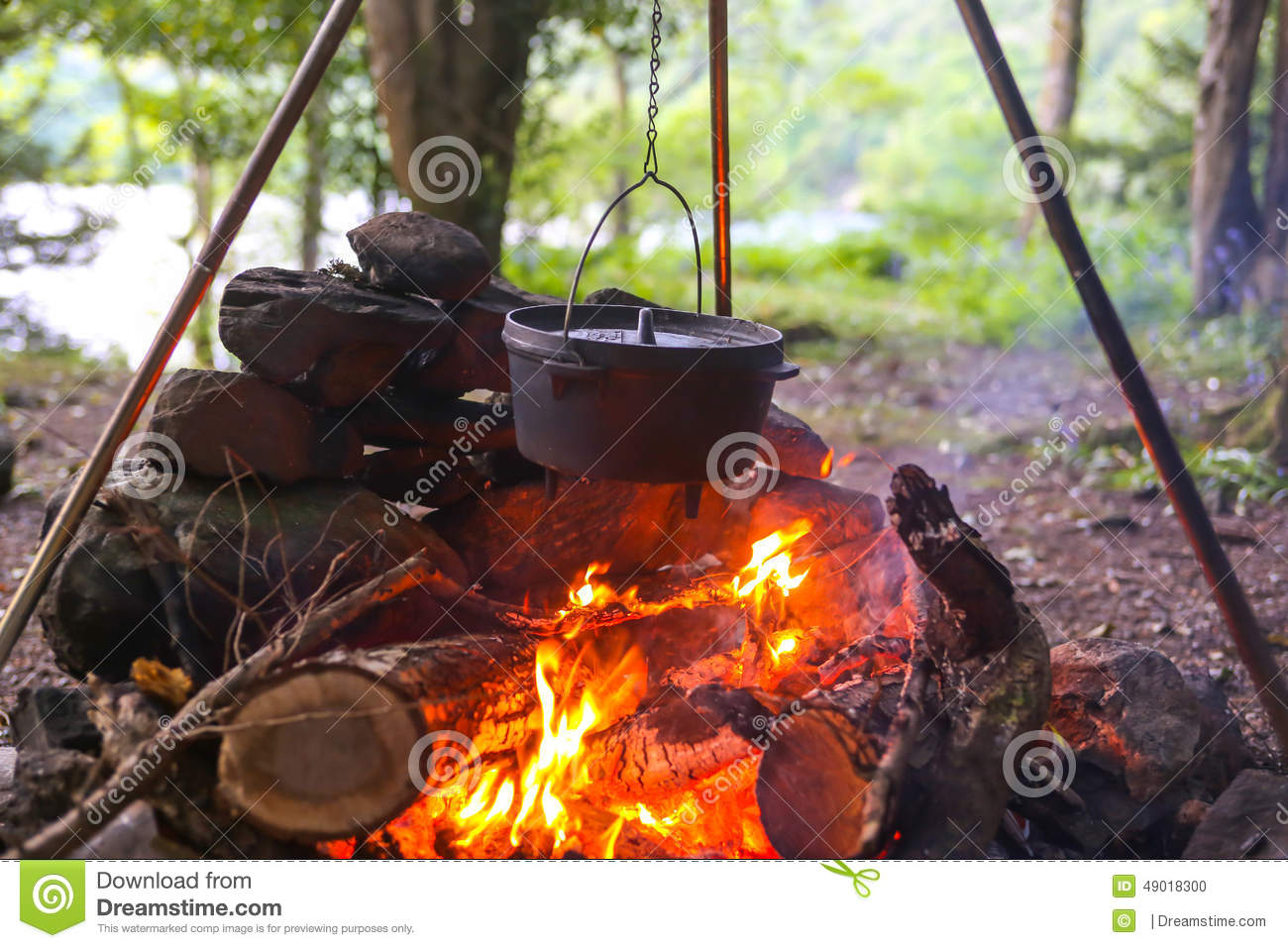 dutch-oven-camp-fire-hung-tripod-over-woods-49018300.jpg